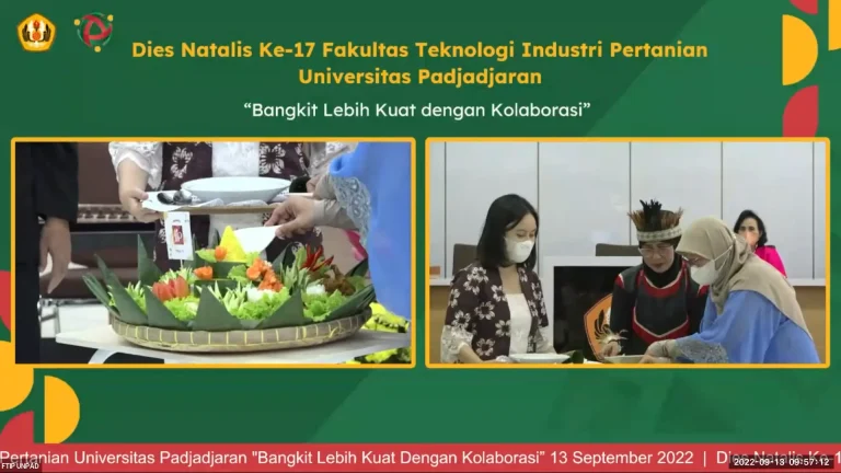 The symbolic tumpeng-cutting ceremony at the FTIP Unpad 2022 Dies Natalis, with faculty representatives gathered around the table.